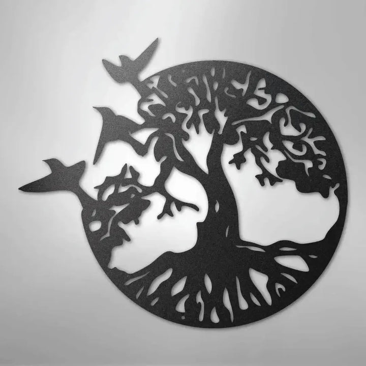 Black metal wall art depicting a tree of life with roots and branches, encircled, with three birds flying.