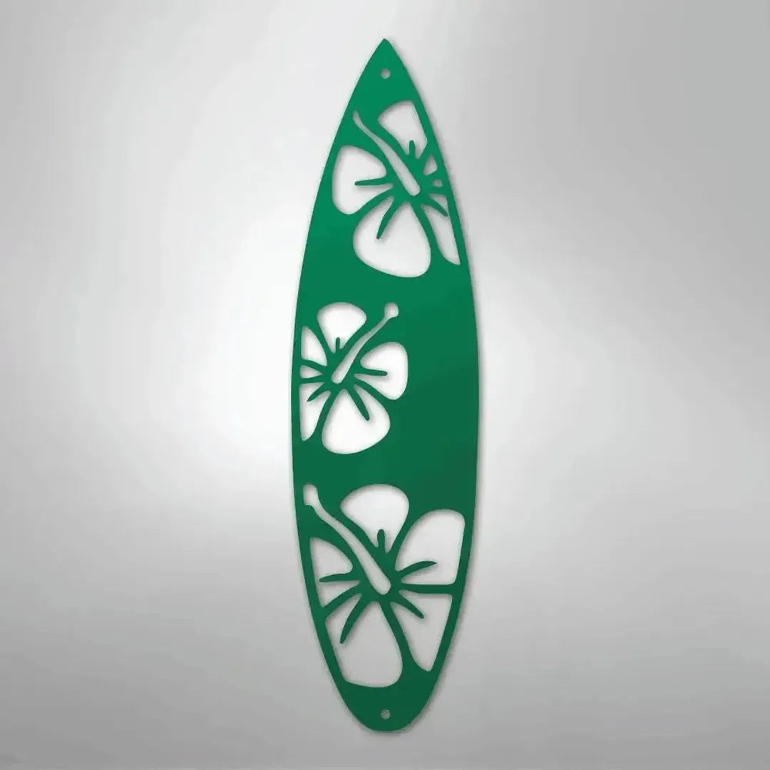 Green metal surfboard wall art with three hibiscus flower cutouts.