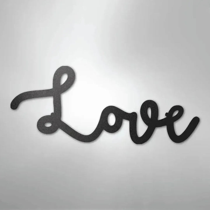 Black script "Love" metal wall art with a textured finish, casting a subtle shadow.