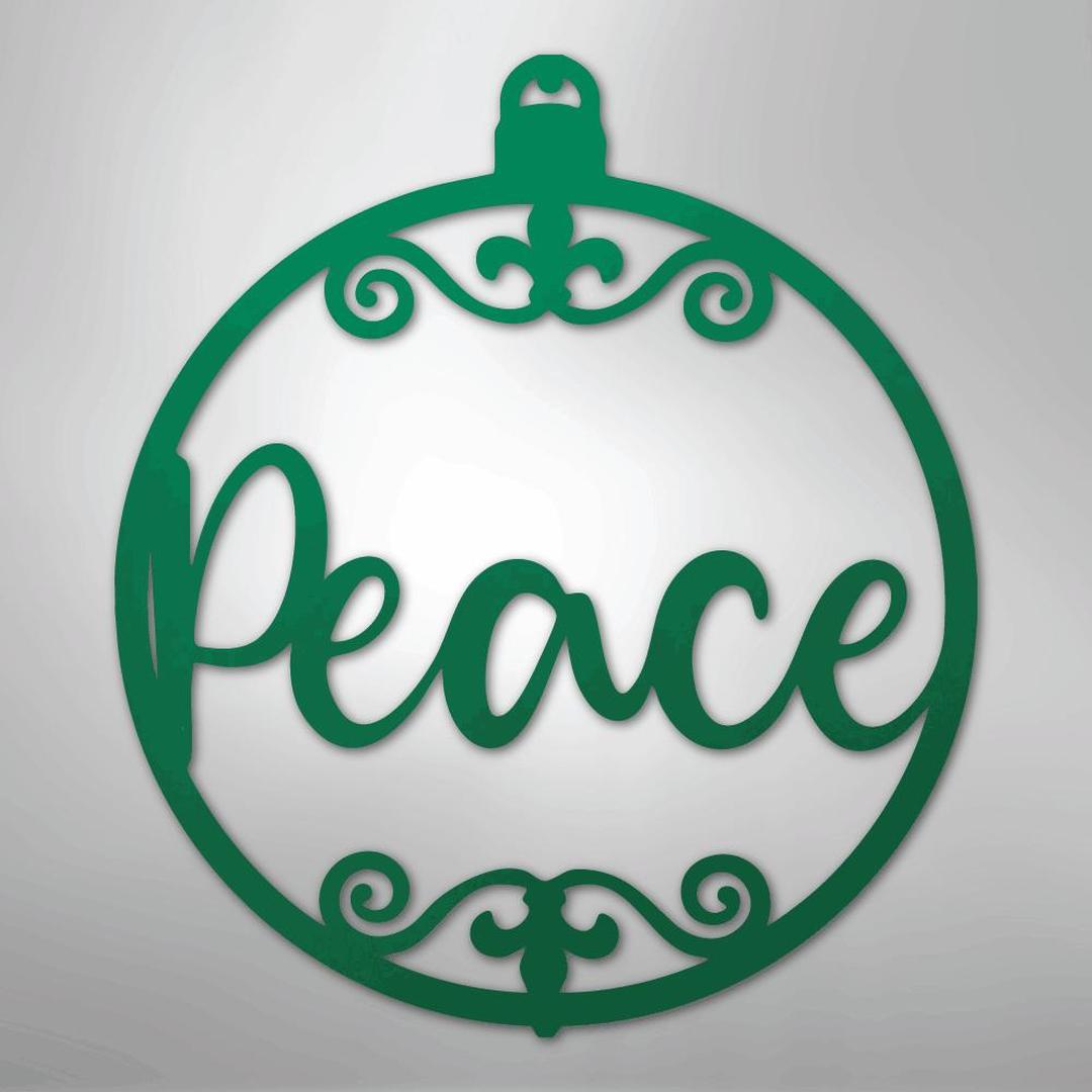 Green metal Christmas ornament wall art with "Peace" in script and scrollwork.