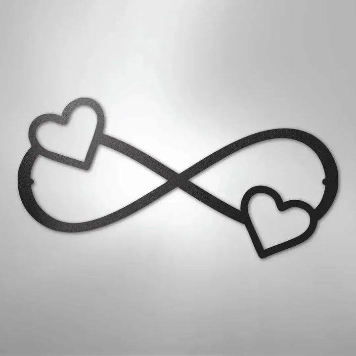 Black metal infinity symbol wall art with two hearts, one on each loop.