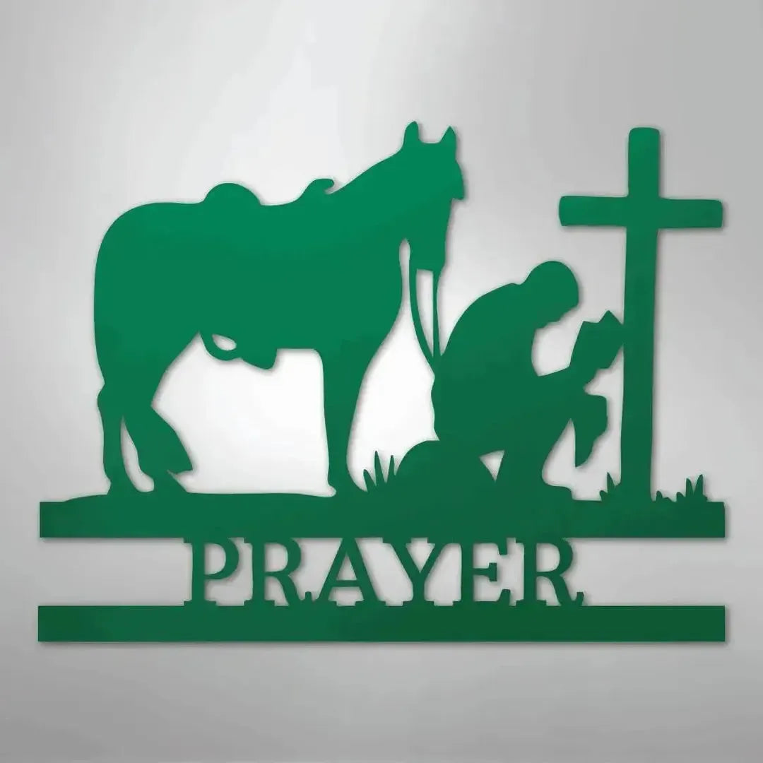 Green metal wall art: kneeling cowboy, horse, cross, and "PRAYER" text.