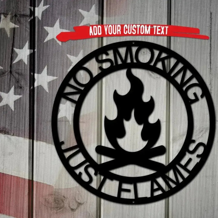 Black metal campfire monogram wall art with "NO SMOKING JUST FLAMES" text, on a rustic wood and flag background.