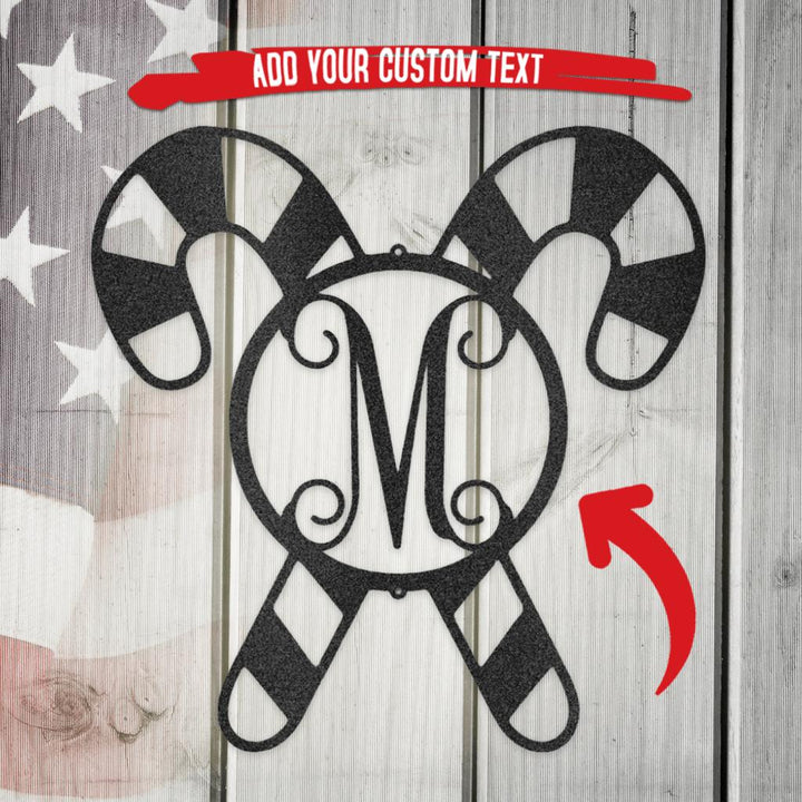 Black metal candy cane wall art with a striped pattern and a central "M" monogram.