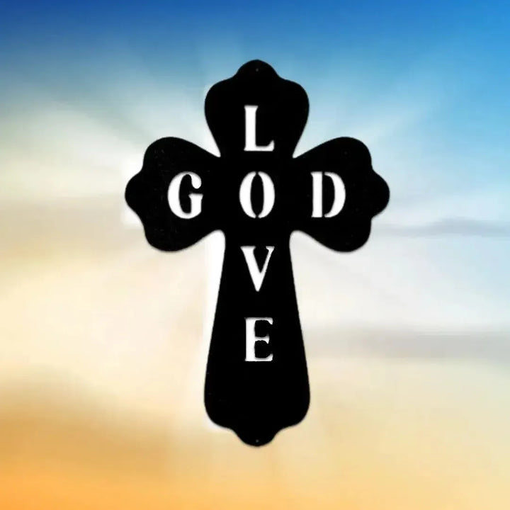 Black metal cross wall art with "GOD LOVE" cut out, against a blue and orange sky.