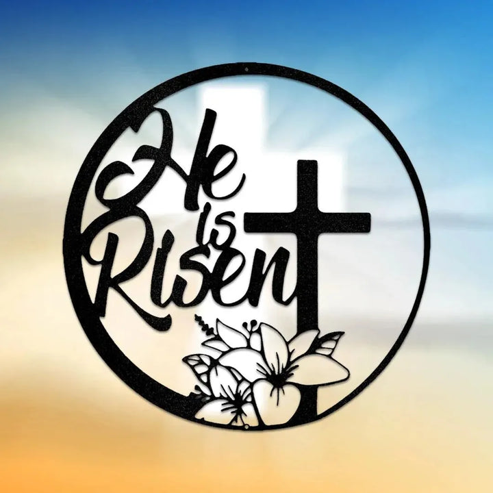 Black metal "He is Risen" wall art with a cross and lilies, in a circular design.