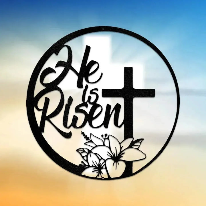 Black metal "He is Risen" wall art with a cross and lilies, in a circular design.