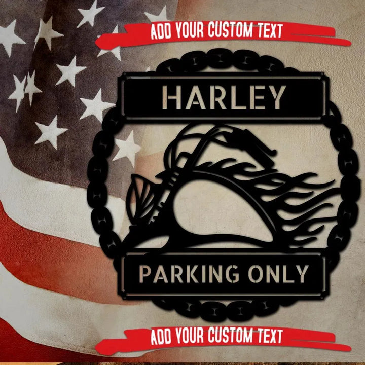 Black metal "HARLEY PARKING ONLY" sign with motorcycle silhouette, framed by a chain, against a US flag.