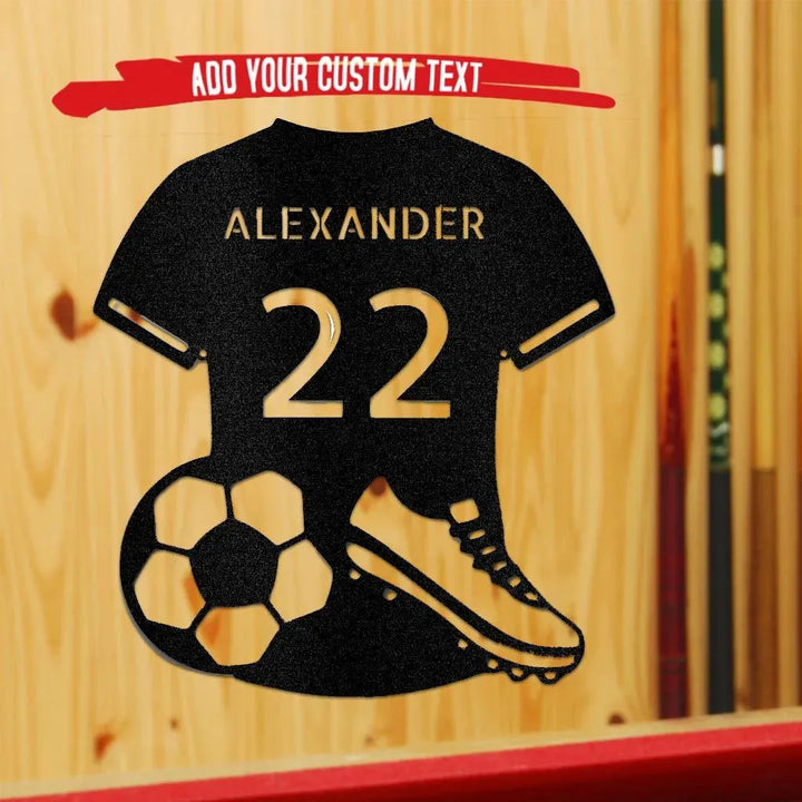 Black metal soccer jersey wall art with "ALEXANDER 22", a soccer ball, and cleat.