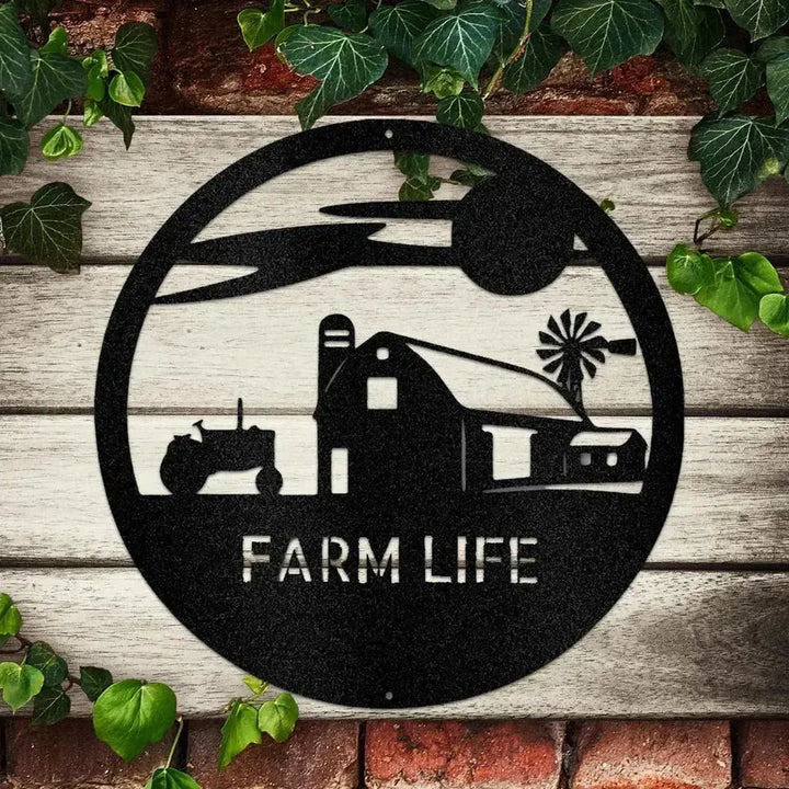 Black metal "Farm Life" monogram with barn, tractor, and windmill silhouette on a rustic wood and brick wall.