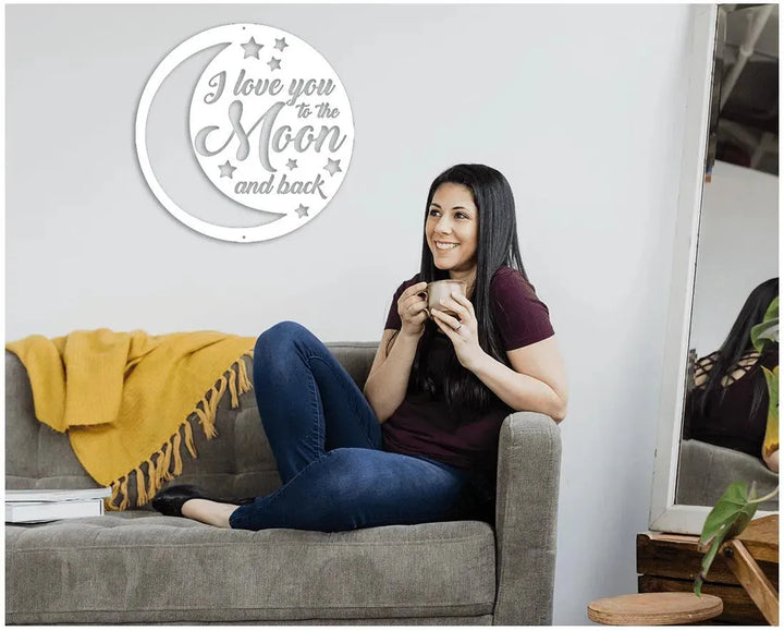 White "I love you to the Moon and back" metal wall art with stars and crescent moon design.