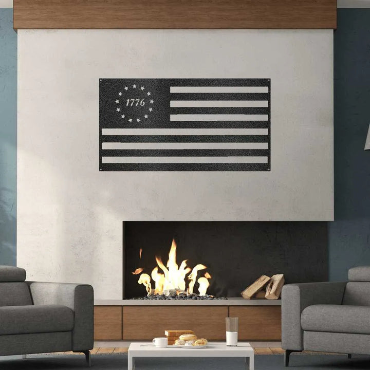 Black metal 1776 Flag wall art with stars and stripes, mounted above a modern fireplace.