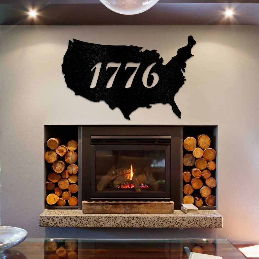 Black metal USA map wall art with "1776" cut out, displayed above a modern fireplace.