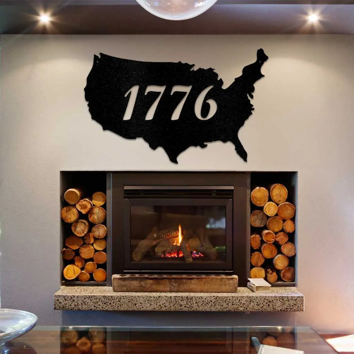 Black metal USA map wall art with "1776" cut out, displayed above a modern fireplace.