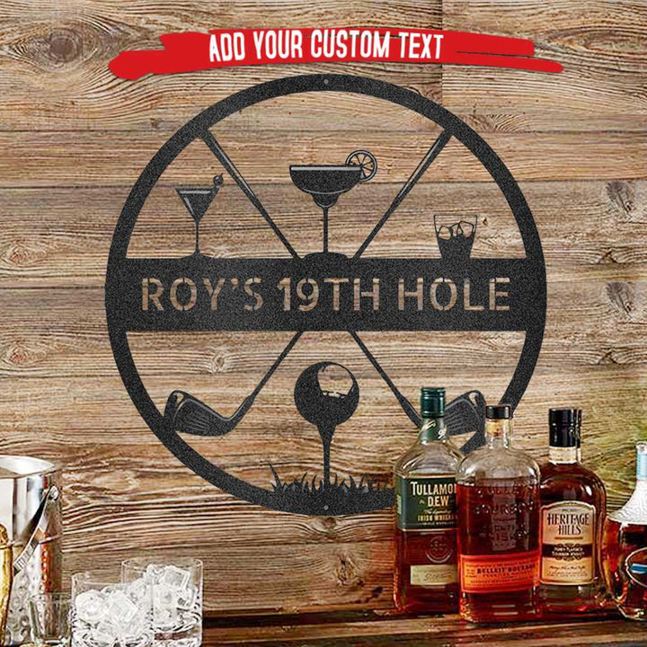 Black metal "ROY'S 19TH HOLE" golf and cocktail monogram sign on a rustic wood background.