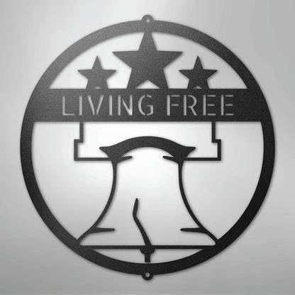 Black metal Liberty Bell monogram wall art with "LIVING FREE" text and three stars.
