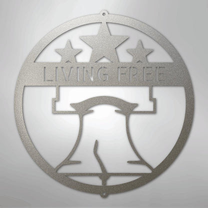 Silver metal Liberty Bell monogram wall art with "LIVING FREE" text and three stars.