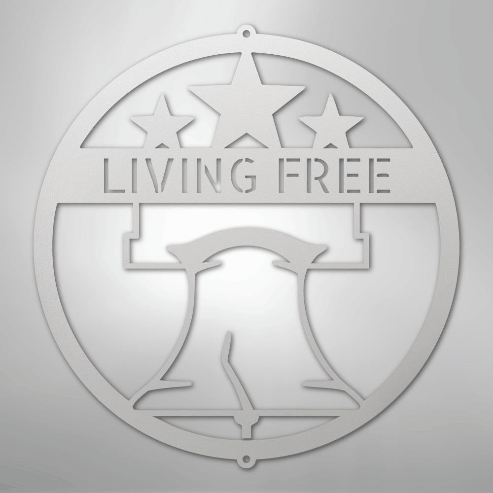 Silver metal wall art featuring a Liberty Bell, three stars, and "LIVING FREE" in a circular design.