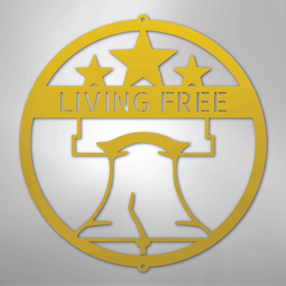 Yellow metal wall art featuring a Liberty Bell and three stars inside a circle, with "LIVING FREE" text.
