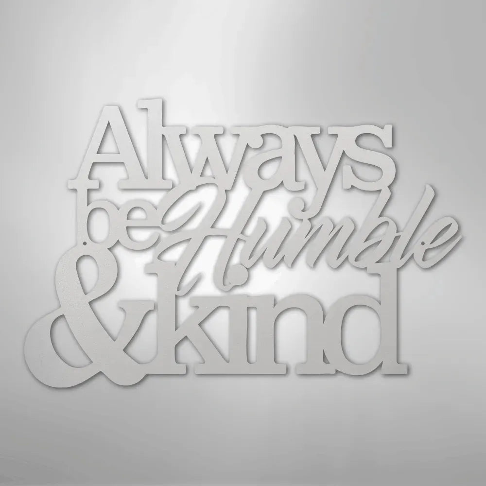 White metal wall art with "Always be Humble & Kind" in varied fonts.
