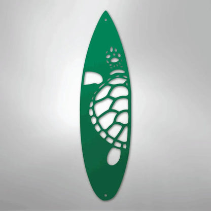 Green metal surfboard wall art with a cutout turtle design.