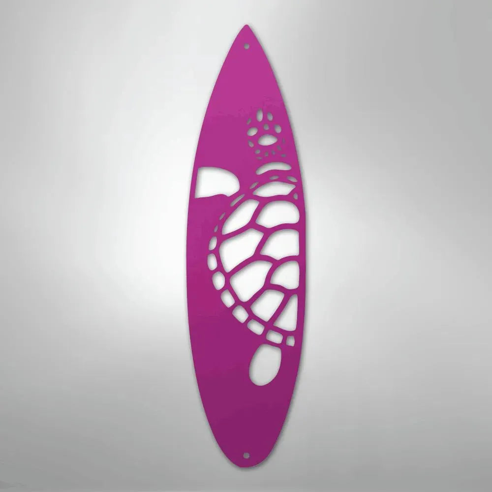 Pink metal surfboard wall art with a cutout turtle design.
