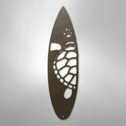 Brown metal wall art shaped like a surfboard with a cutout design of a sea turtle.