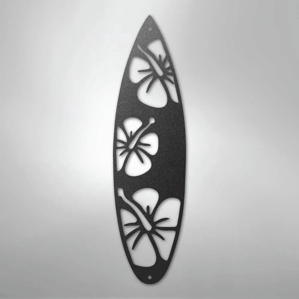 Black metal surfboard wall art with three hibiscus flower cutouts.