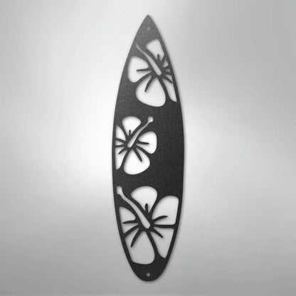 Black metal surfboard wall art with three hibiscus flower cutouts.