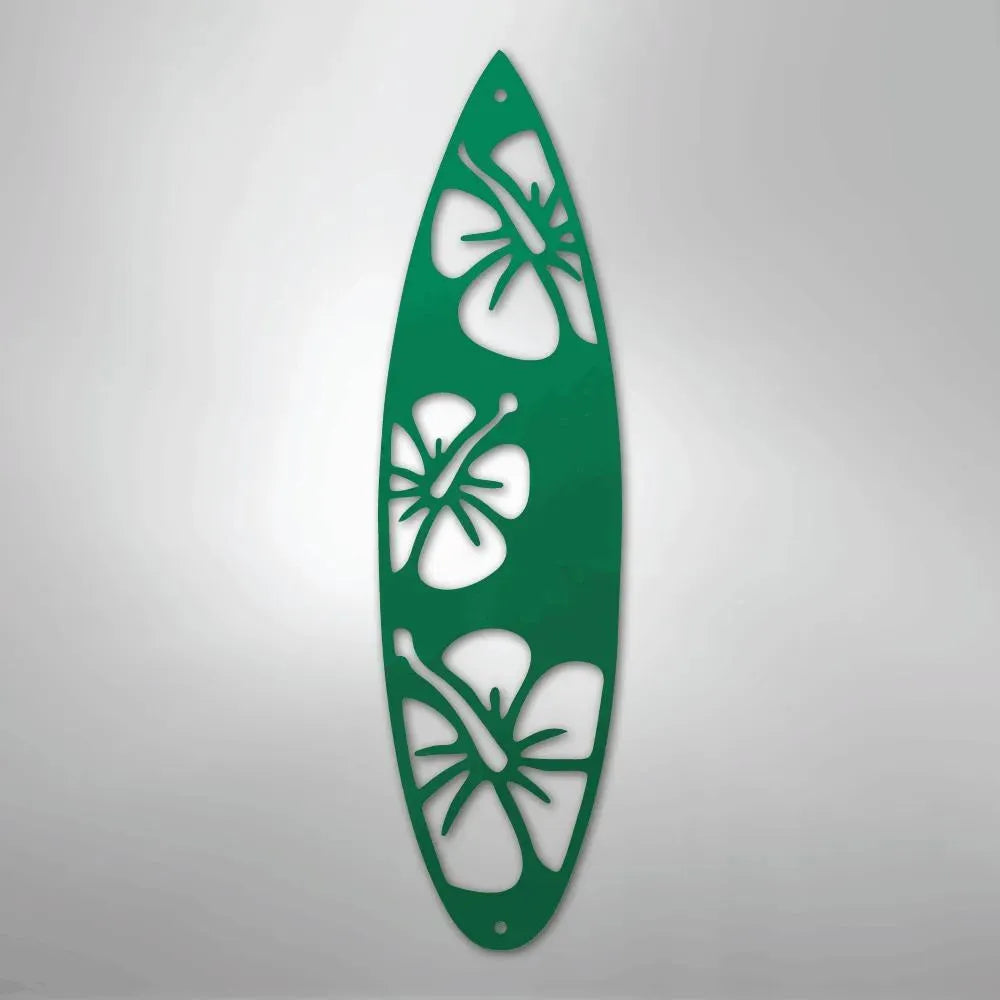 Green metal surfboard wall art with three hibiscus flower cutouts.