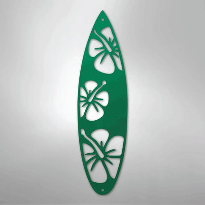 Green metal surfboard wall art with three hibiscus flower cutouts.