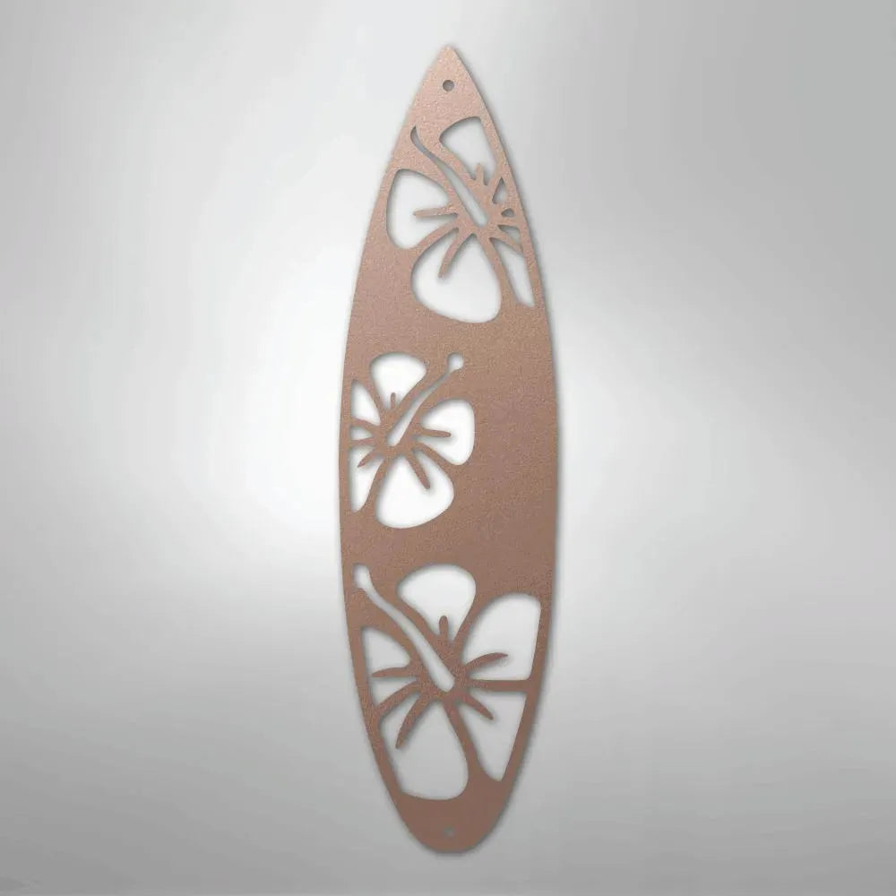 Rose gold metal surfboard wall art with three hibiscus flower cutouts.