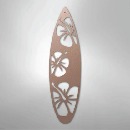 Rose gold metal surfboard wall art with three hibiscus flower cutouts.