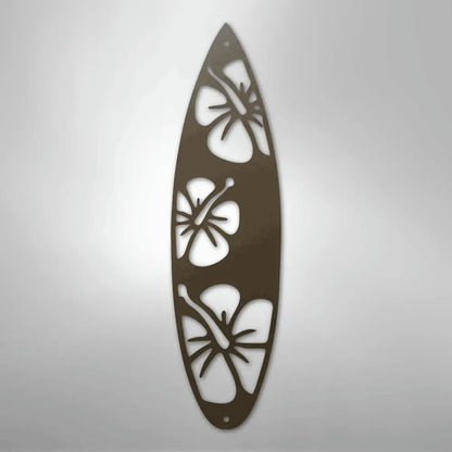 Brown metal surfboard wall art with three cutout hibiscus flower designs.