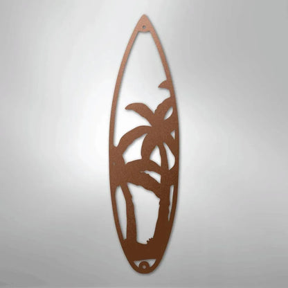 Copper metal surfboard wall art with palm tree cutout design.