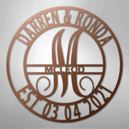 Round copper metal wall art with "Darren & Ronda," a large "M," "McLeod," and "Est. 03 04 2021" cut out.