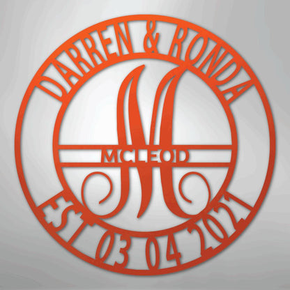 Orange metal family name wall art with "Darren & Ronda," a large "M," "McLeod," and "Est. 03 04 2021" in a circular design.