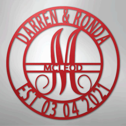 Red metal wall art with "Darren & Ronda," "McLeod," "Est. 03 04 2021," and a large "M" in a circular design.