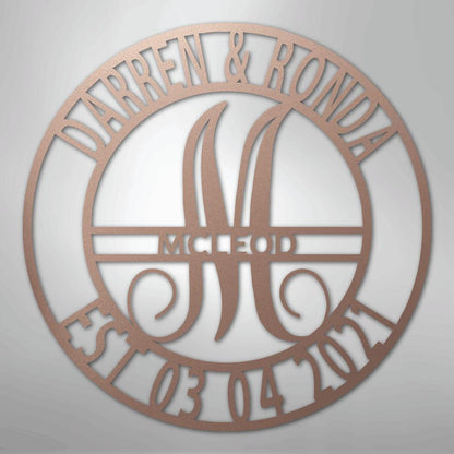 Rose gold metal wall art with "Darren & Ronda," a large "M," "McLeod," and "Est. 03.04.2021" in a circular design.