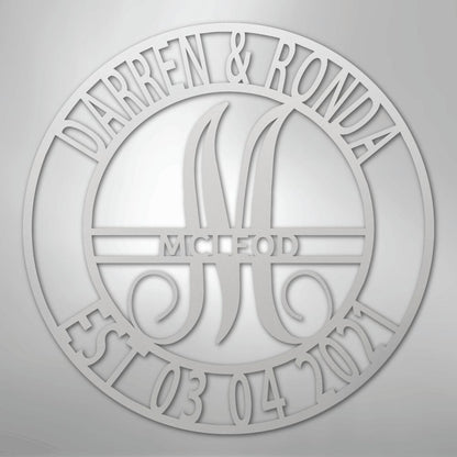 Custom silver metal wall art with "Darren & Ronda," a large "M," "McLeod," and "Est 03 04 2021" in a circular design.