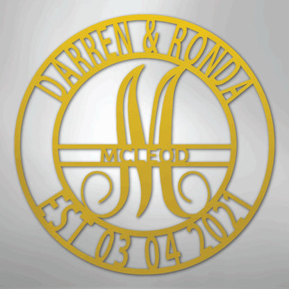Gold metal wall art with "Darren & Ronda," a large "M" for McLeod, and "Est. 03.04.2021" in a circular design.