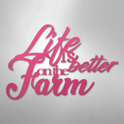Pink powder-coated steel "Life is better on the Farm" quote wall art in a cursive font.