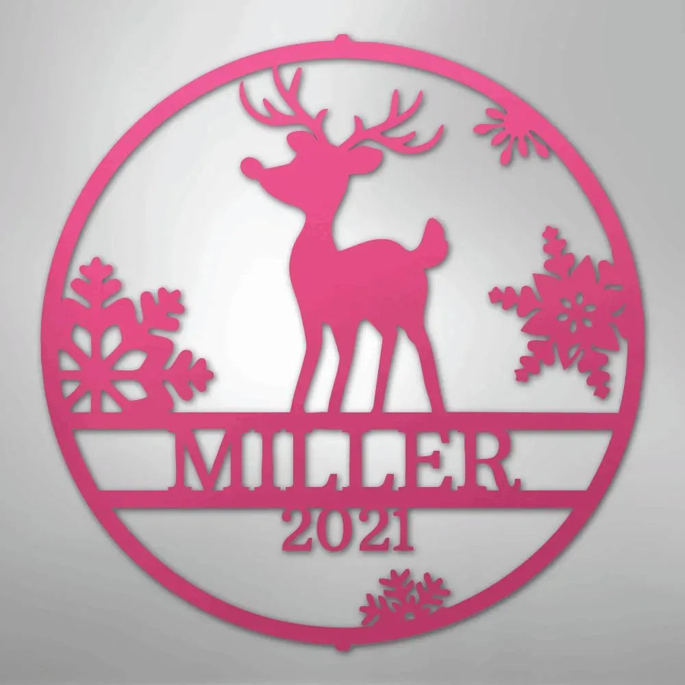 Pink metal wall art: circular Rudolph deer design with snowflakes, personalized "MILLER 2021" text.