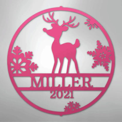 Pink metal wall art: circular Rudolph deer design with snowflakes, personalized "MILLER 2021" text.