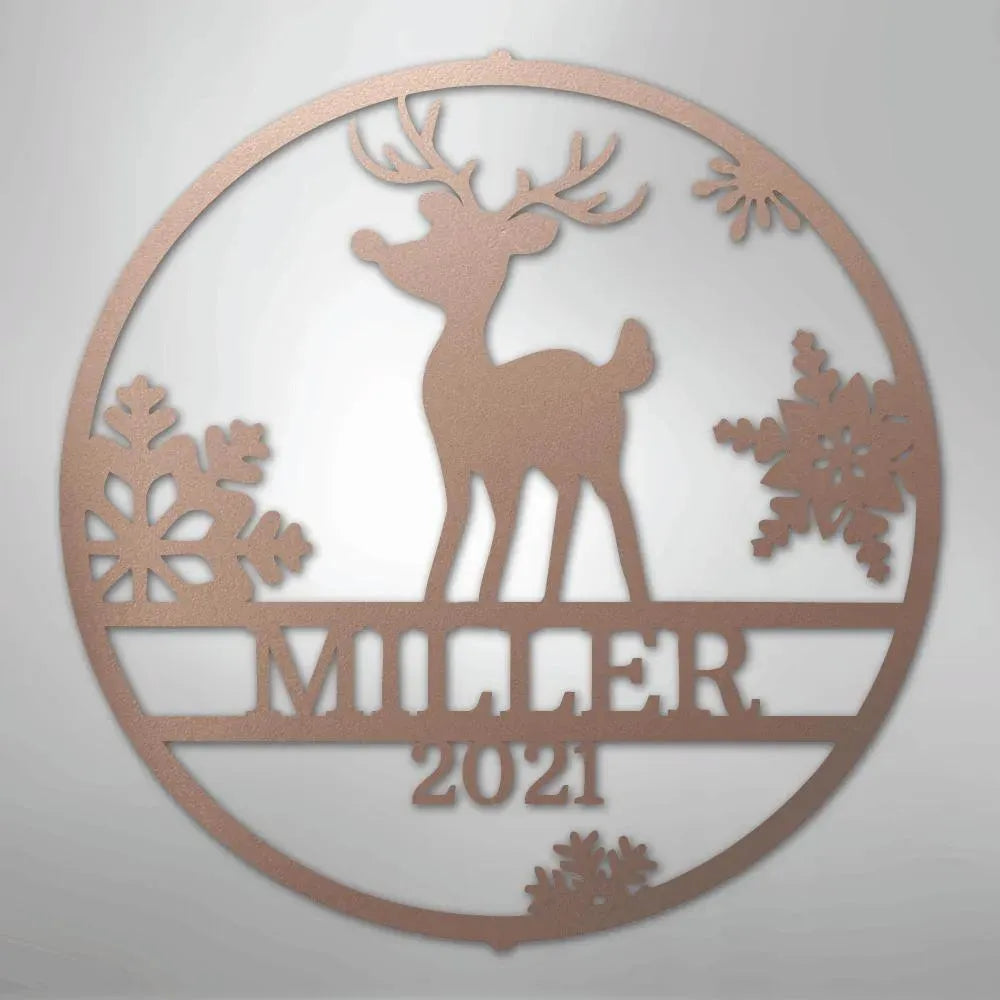 Rose gold metal wall art with a reindeer, snowflakes, and "MILLER 2021" custom text in a circular design.