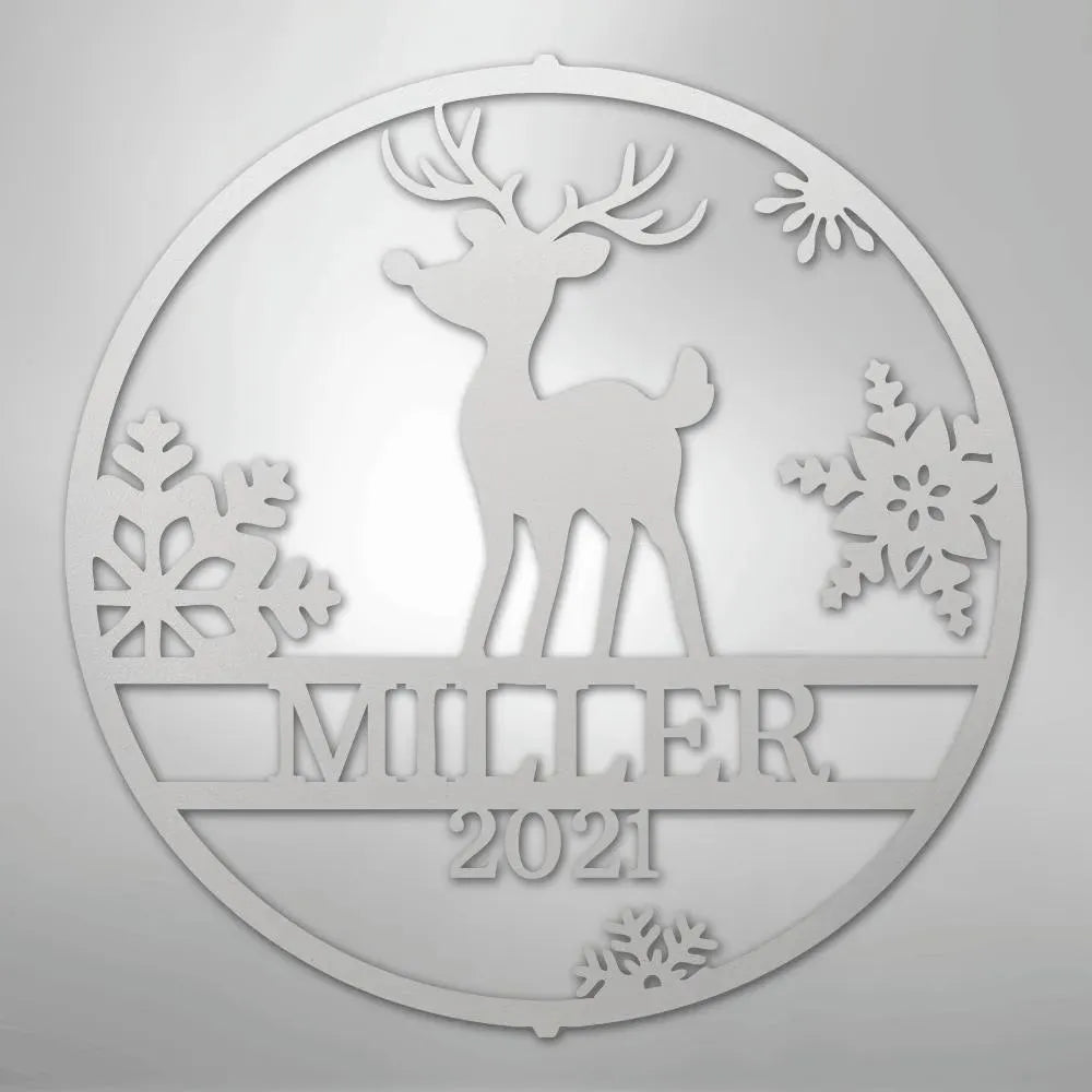 Silver metal wall art with a reindeer, snowflakes, "MILLER," and "2021" in a circular design.