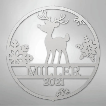 Silver metal wall art with a reindeer, snowflakes, "MILLER," and "2021" in a circular design.