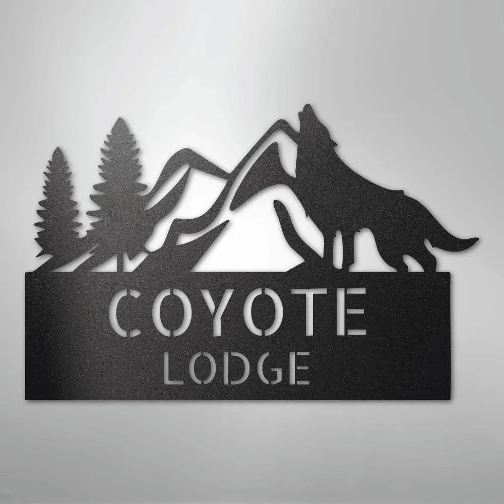 Black metal wall art featuring a howling wolf, pine trees, mountains, and "COYOTE LODGE" text.