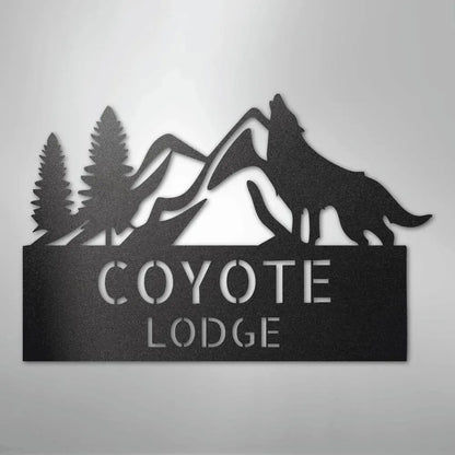 Black metal wall art featuring a howling wolf, pine trees, mountains, and "COYOTE LODGE" text.