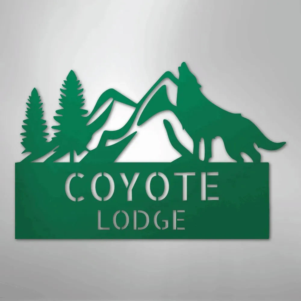 Green metal wall art featuring mountains, pine trees, a howling wolf, and "COYOTE LODGE" text.